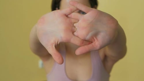 Woman Stretching Hands as a Warm-Up Indoors