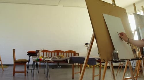 Artist Drawing on Easel in an Art Studio