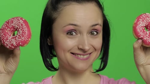 Happy Beautiful Young Girl Posing and Having Fun with Donuts. Chroma Key