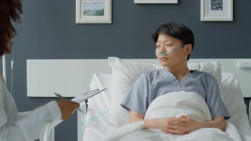 Doctor Working with Asian Female Patient in Hospital