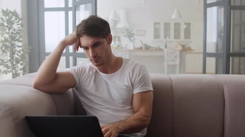 Focused Businessman Using Laptop Computer at Home Office in Slow Motion