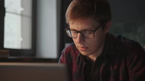 Young Adult Concentrating on Computer Screen