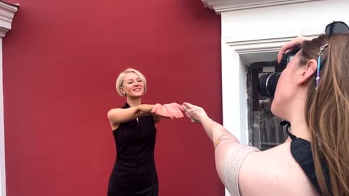 Fashion Model Posing for Photographer in Urban Setting