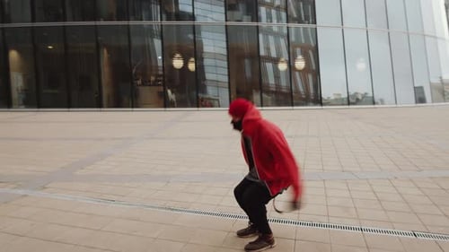 Young Sporty Man Performing Parkour Backflip Outdoors