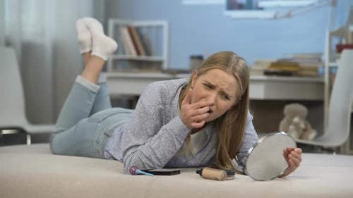 Young Lady Lying on Bed, Worried About Her Skin Problems, Age-Related Changes