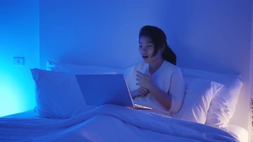Woman Video Calling from Bed at Night