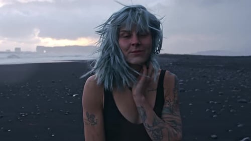 Smiling Cool Girl On Black Sand Beach