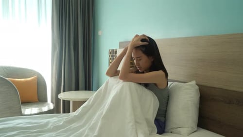 Asian woman thinking about problems and suffering from depression