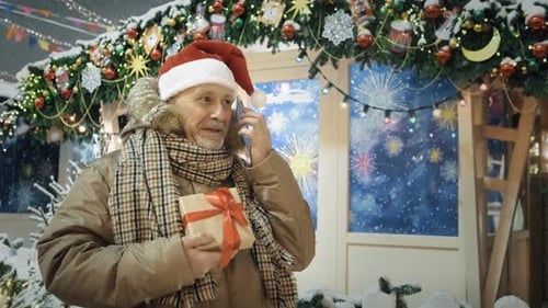 Adult with Gift Talking on Phone at Christmas Market