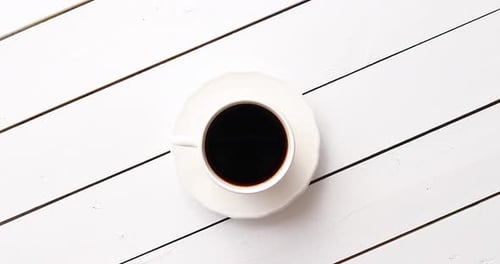 Overhead Shot of Coffee Cup on White Wood