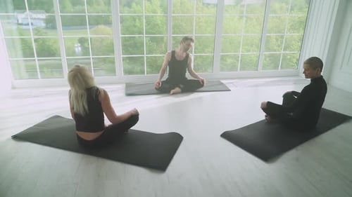 Wellness Joint Yoga Classes a Man Teaches Yoga to Two Adult Women People of Different Ages Doing