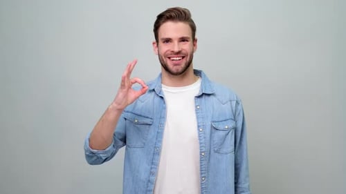 Man Smiles and Gives OK Hand Gesture