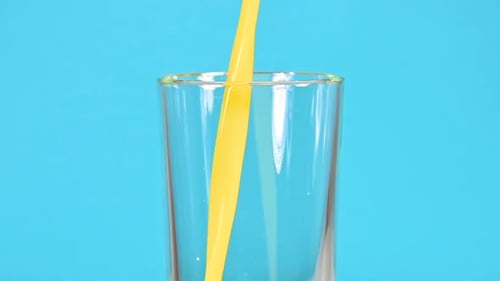 Bright Orange Juice Pouring Into Glass