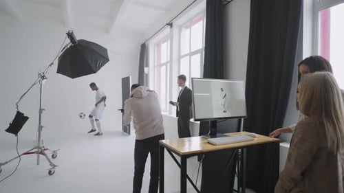 Making Advertising Poster for Sportive Company with Football Player Guy is Doing Keepie Uppie