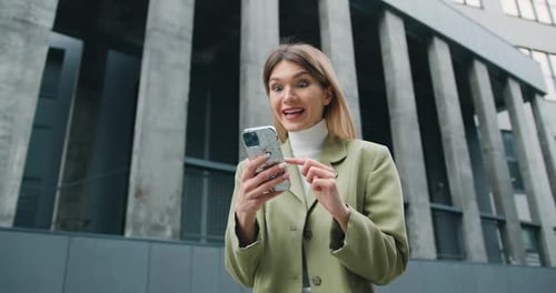 Excited Woman Reacting to Good News on Phone