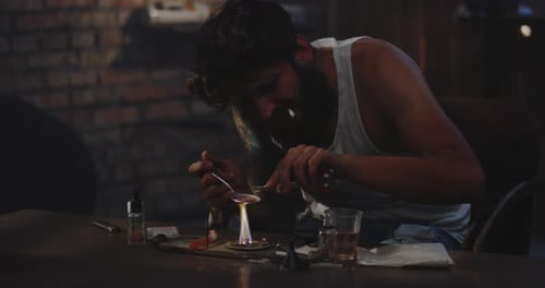 Man Heating Drug in a Spoon