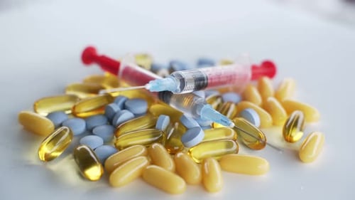 Pills and Syringe for Medical Treatment