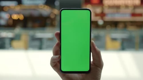 Close Up of Male Hand Holding Smartphone with Green Screen