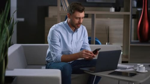 Smiling Entrepreneur Call Mobile Using Laptop Research Business Data in Office