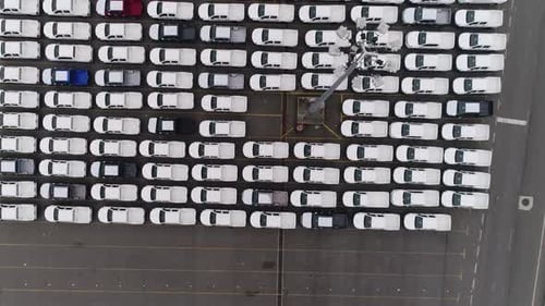Motion Past Long Rows of Finished Cars in Factory Warehouse
