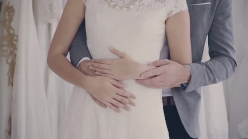 Romantic Couple Embracing in Bridal Dress Shop