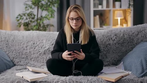 Girl Using Tablet While Studying at Home