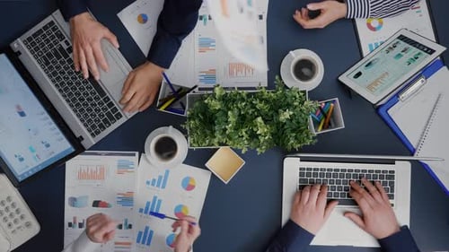 Top View of Business Teamwork Analyzing Company Accounting Paperwork