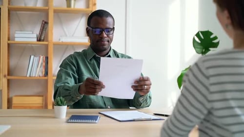 Professional Man Receives Resume During an Interview