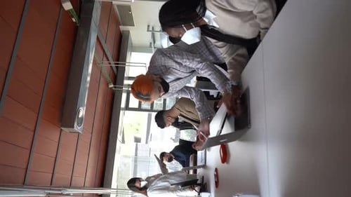 Company of multiethnic colleagues in masks working together in office