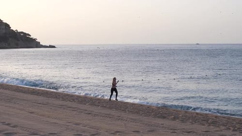 Drone View of Fit Woman During Speed Run on Beach