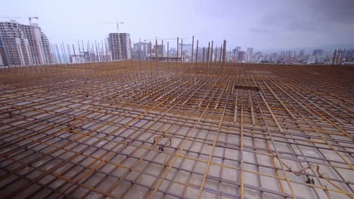Iron reinforcement is basis for pouring foundation of house with concrete slab.