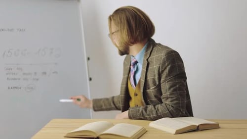 Serious Teacher Lectures Students From His Desk