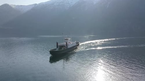 A Ferry Transporting Passengers Over a Fjord in Norway, Drone Flyby Shot