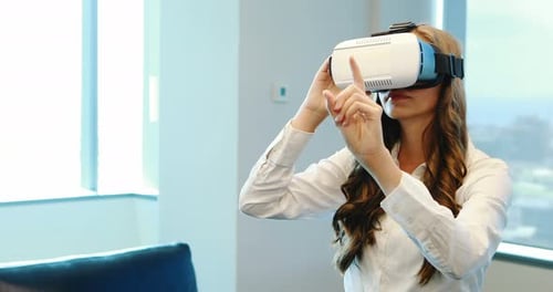 Young Woman Uses VR Headset in Modern Office
