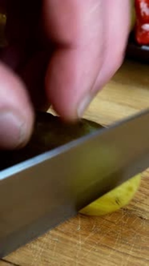 Pickle Sliced on Cutting Board with Knife