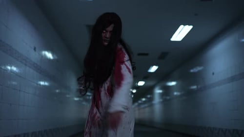 Figure Stumbles Through Dark Tunnel at Night