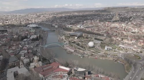 Aerial view of Tbilisi city central park and Bridge of Peace. Beautiful cityscape of old Tbilisi