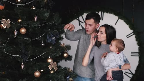 Family Decorating Christmas Tree in Home Interior
