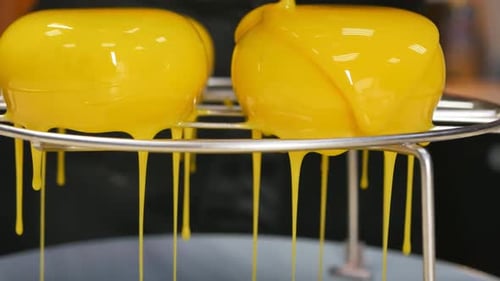 Bright Yellow Icing Poured over Dome Shaped Cakes