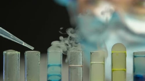 Close Up Scientist Using Pipette on Test Tubes