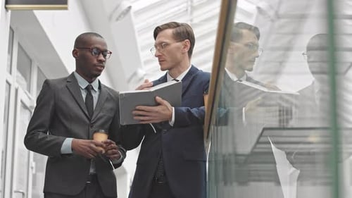Businessmen Discussing Project in Modern Office Building