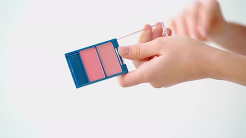 Female Hands Holding Make Up Palette with Blush Close Up