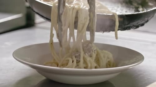 Pasta Dish Being Plated in Restaurant Kitchen