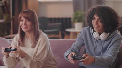 Woman and Teen Play Video Games on Couch