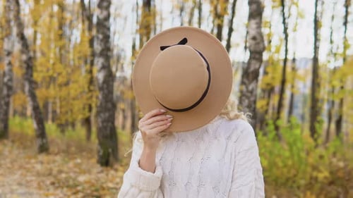 Portrait of Smiling Happy Cheerful Woman with Brown Hat in Autumn Park