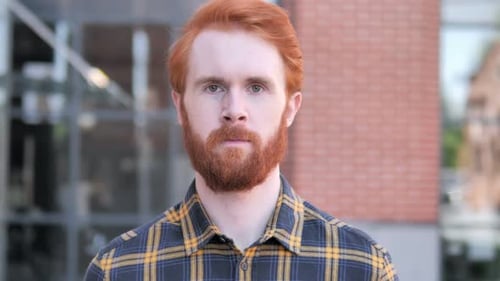 Auburn-Haired Man Stares Intently