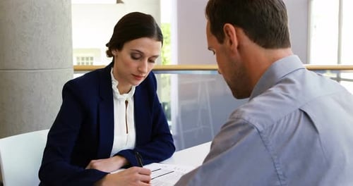 Executives discussing with each other in conference centre