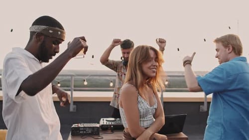 Friends Dance at a Rooftop Celebration