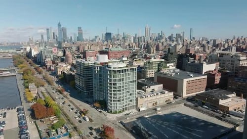 Forwards Fly Above Hudson River Waterfront and Buildings in Town