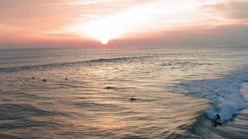 Aerial View of Surfer Riding Sunset Ocean Wave. Drone Shot Surfing Ocean Lifestyle, Extreme Sports.